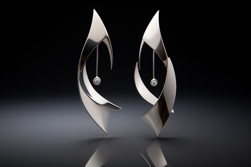 Stylish hypoallergenic metal earrings displayed against a neutral background, with a selection of allergenic earrings for contrast