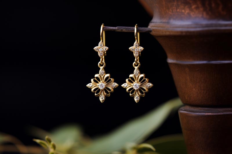 Close-up shot of intricate gold cross earrings from Joias & More's collection, embodying the perfect blend of tradition and modernity